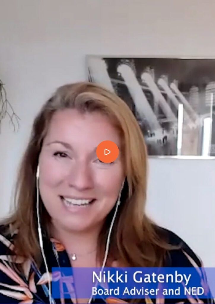 "At a Nedonboard virtual meeting, a woman smiles warmly while engaged in a video call, displaying happiness and active participation."