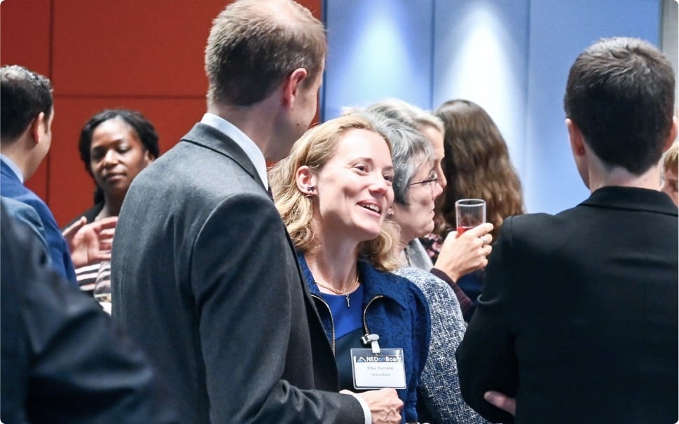 Attendees interacting and socializing at a crowded event, displaying a sense of community.