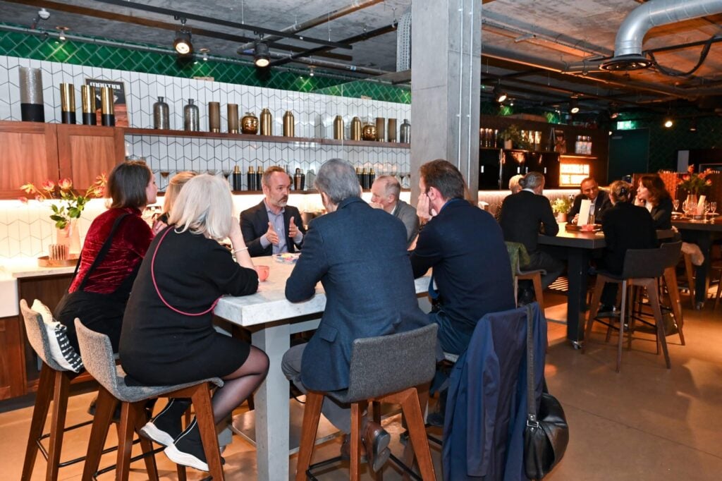Group of people sitting and discussing something
